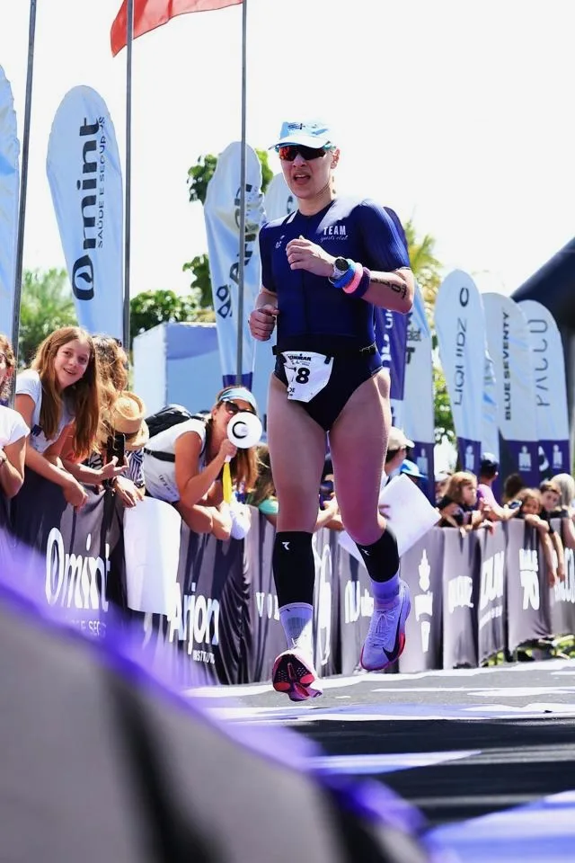 Zoe running at Ironman 70.3 Brasilia, bib 8, crowd cheering